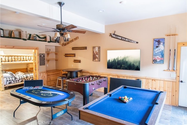 rec room with ceiling fan, beam ceiling, hardwood / wood-style floors, and billiards