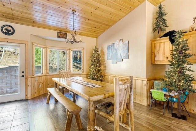 dining room featuring vaulted ceiling, wooden ceiling, a chandelier, and hardwood / wood-style floors