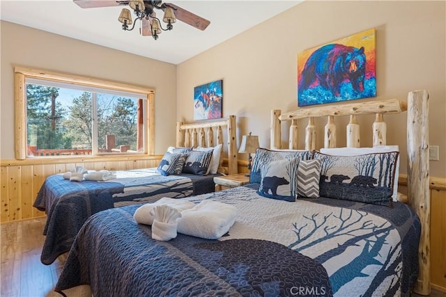 bedroom with ceiling fan and hardwood / wood-style flooring