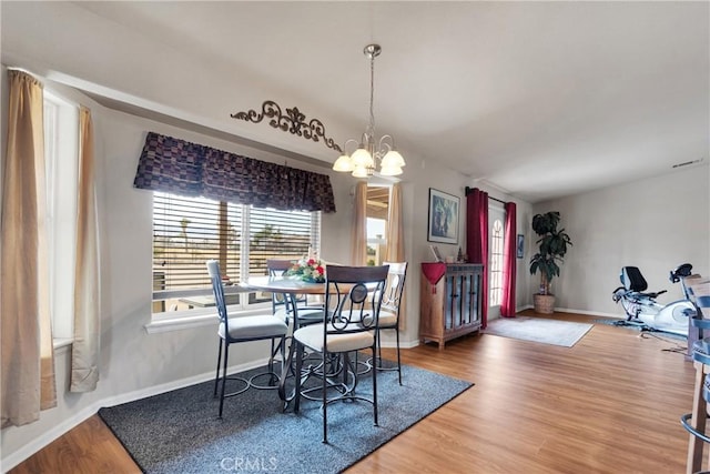 dining area featuring a chandelier and hardwood / wood-style floors