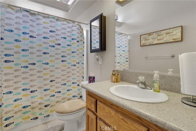 bathroom featuring toilet, tile patterned floors, vanity, and curtained shower