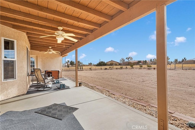 view of patio with ceiling fan and exterior fireplace