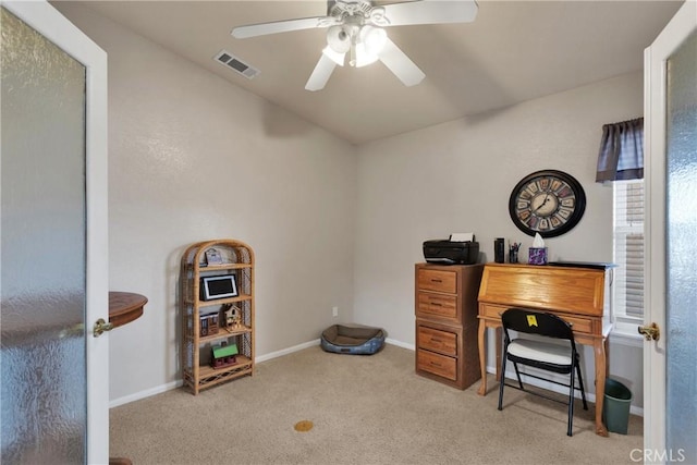 carpeted office space featuring ceiling fan