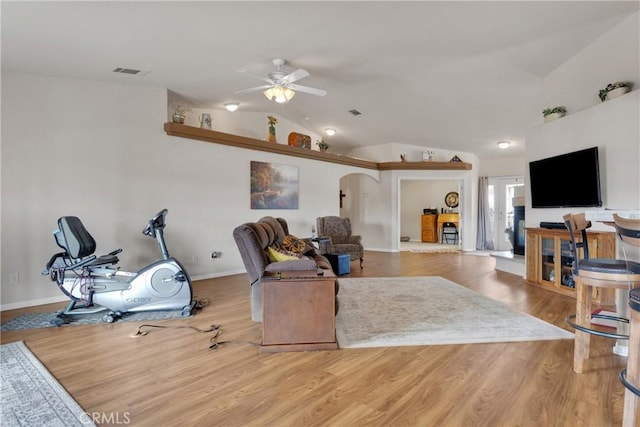 living room featuring light wood-type flooring, ceiling fan, and vaulted ceiling