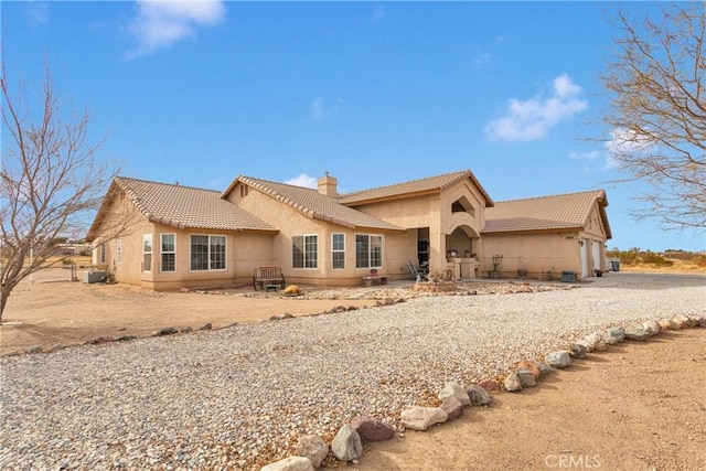 view of front of property with central AC and a garage