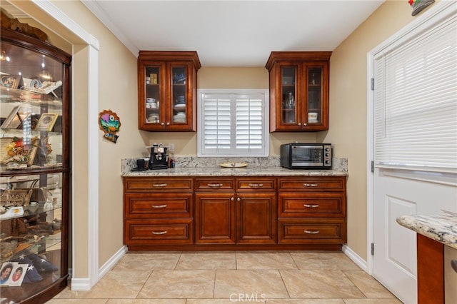 kitchen with light tile patterned floors and light stone countertops