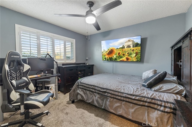 carpeted bedroom featuring a textured ceiling and ceiling fan