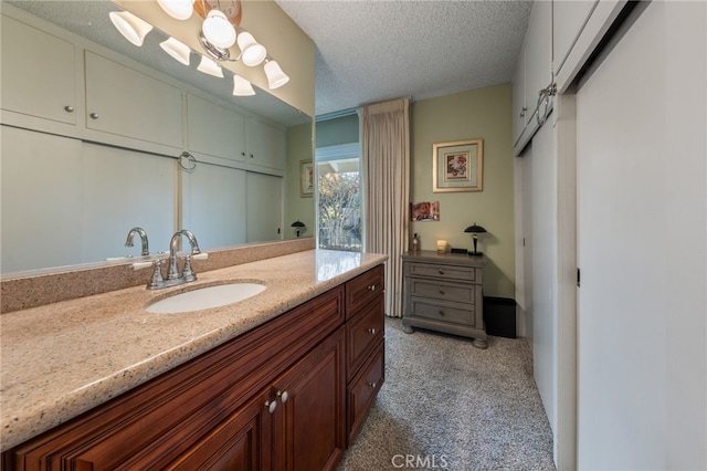 bathroom featuring a textured ceiling and vanity