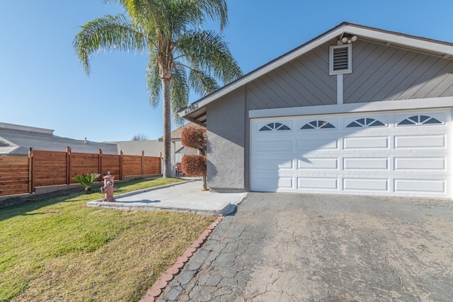 garage featuring a lawn