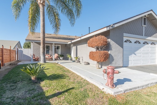 ranch-style home featuring a garage and a front yard