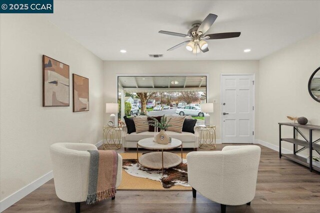 living room featuring ceiling fan and hardwood / wood-style floors