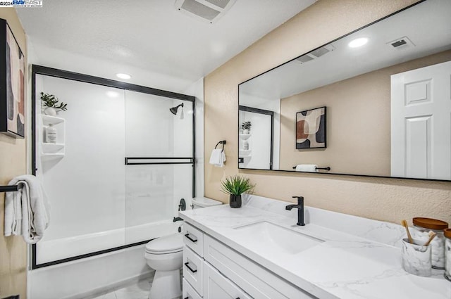 full bathroom with toilet, enclosed tub / shower combo, and vanity