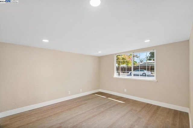 spare room featuring wood-type flooring