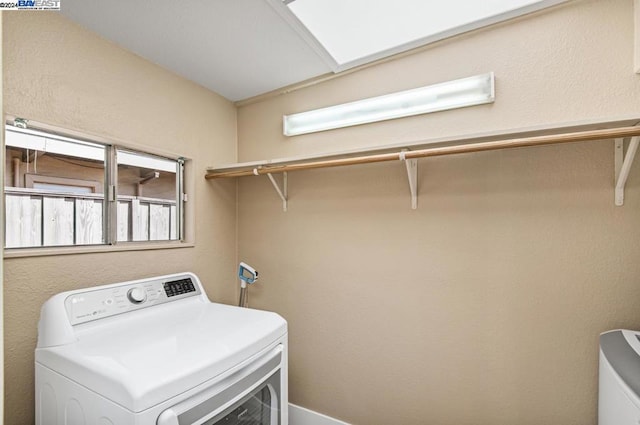 clothes washing area with washer / dryer