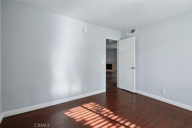 spare room with dark hardwood / wood-style floors