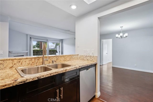 kitchen with decorative light fixtures, dishwasher, sink, a notable chandelier, and light stone countertops