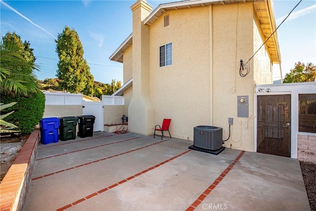 back of house with cooling unit and a patio