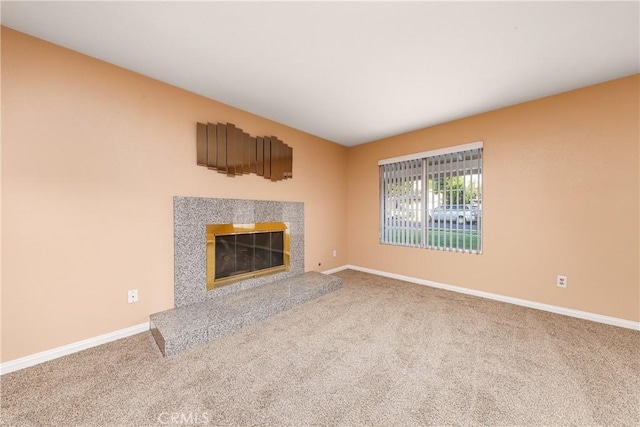 unfurnished living room featuring a premium fireplace and carpet flooring