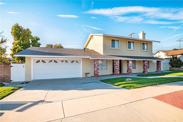 view of front of home featuring a front lawn and a garage