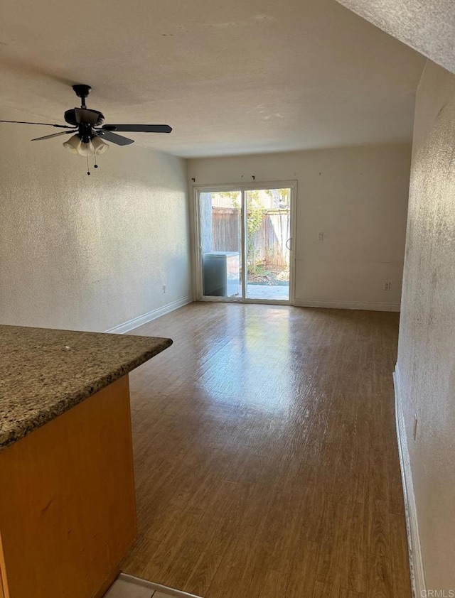 unfurnished room featuring ceiling fan and hardwood / wood-style flooring