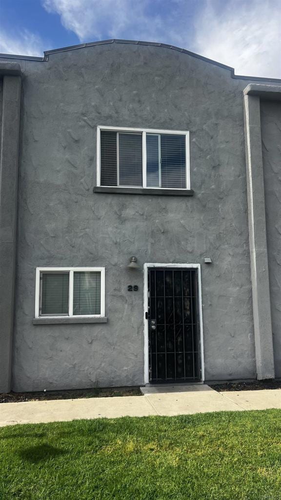 851 S Mollison Ave Unit 29, El Cajon, CA 92020 - back of property with stucco siding and a yard