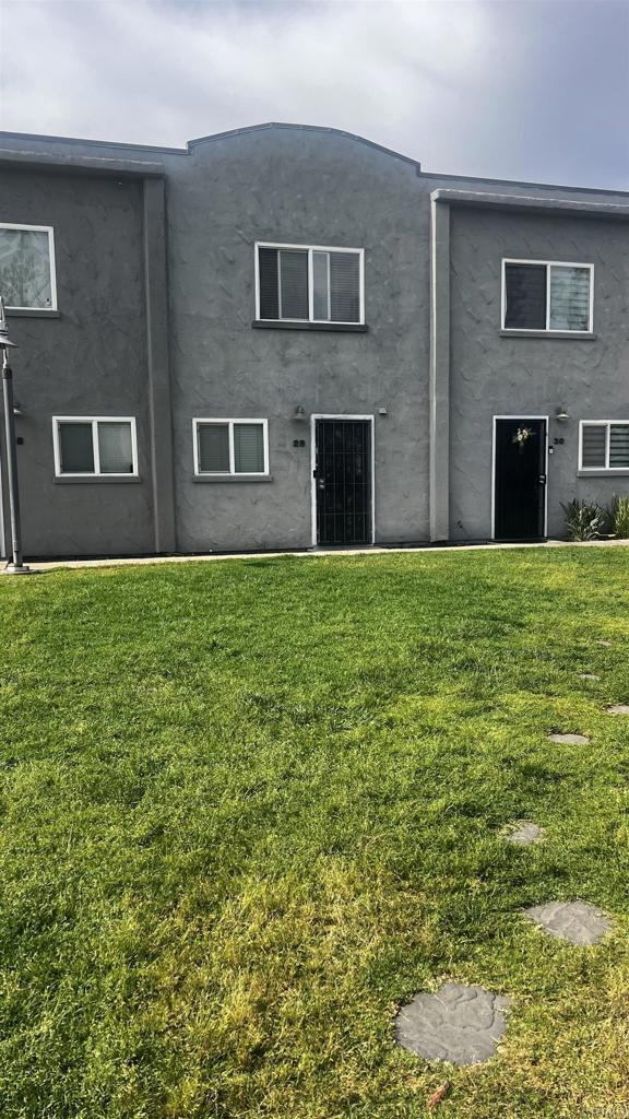 851 S Mollison Ave Unit 29, El Cajon, CA 92020 - back of house featuring a lawn and stucco siding