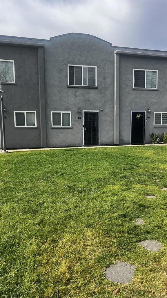 851 S Mollison Ave Unit 29, El Cajon, CA 92020 - back of house featuring a lawn and stucco siding