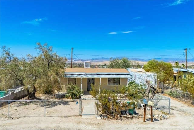 view of front of home with a mountain view and covered porch