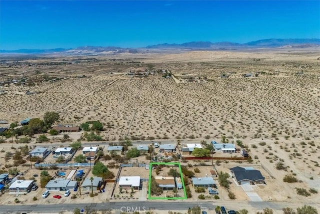 birds eye view of property with a mountain view