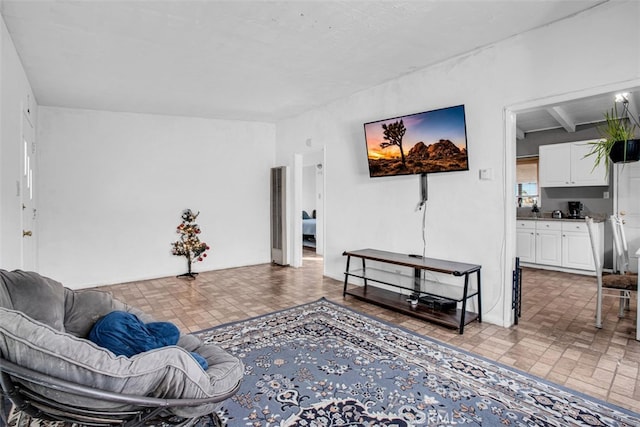 living room featuring beam ceiling