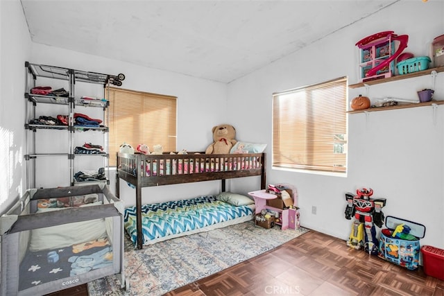 bedroom with dark parquet floors