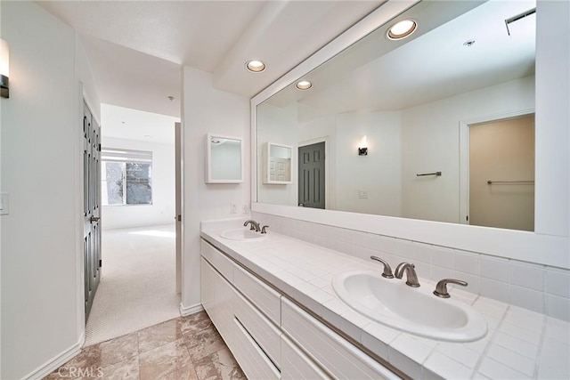 bathroom featuring tasteful backsplash and vanity