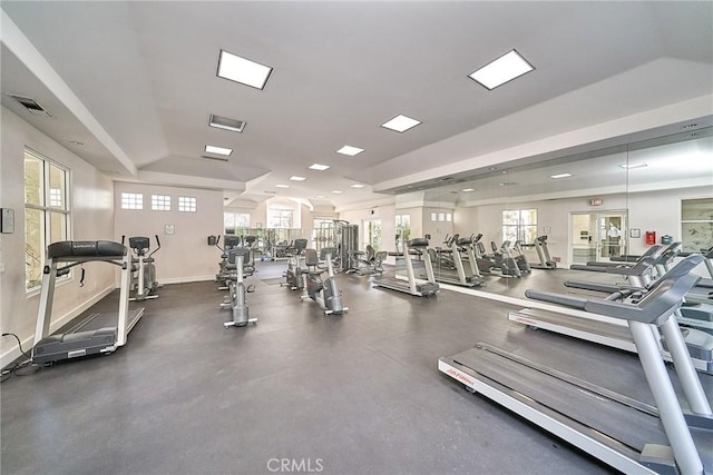 exercise room featuring lofted ceiling and a healthy amount of sunlight