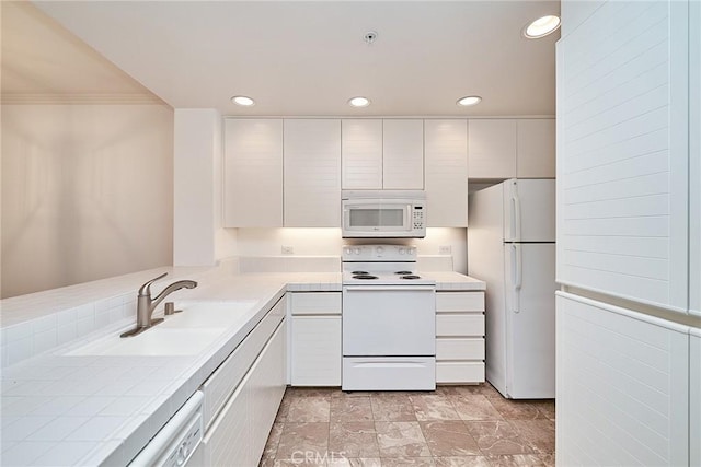 kitchen featuring tile countertops, sink, crown molding, white appliances, and white cabinetry