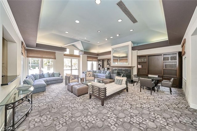 carpeted living room featuring a raised ceiling