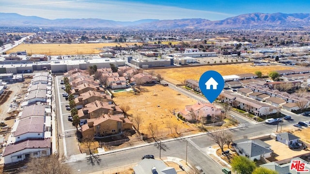 birds eye view of property with a mountain view