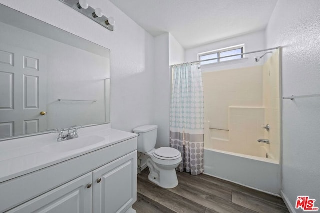 full bathroom featuring toilet, shower / bath combination with curtain, wood-type flooring, and vanity