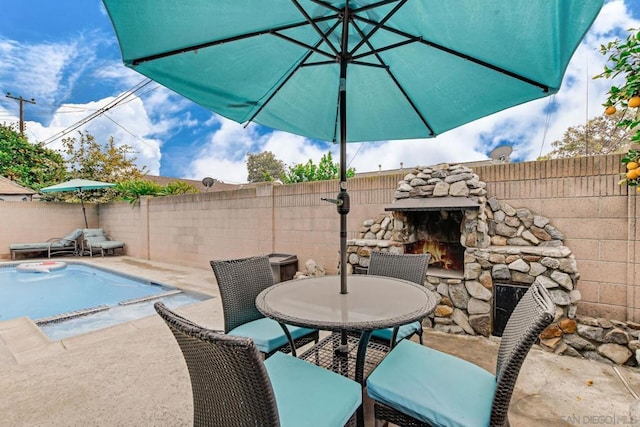 view of patio / terrace featuring an outdoor stone fireplace