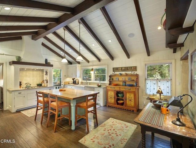 dining room with lofted ceiling with beams, dark hardwood / wood-style floors, and wooden ceiling