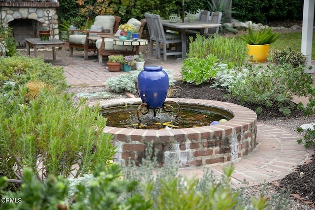 view of yard featuring exterior fireplace and a patio