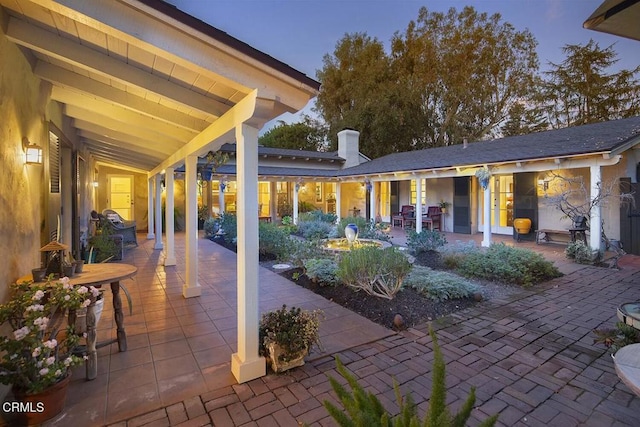 view of patio terrace at dusk