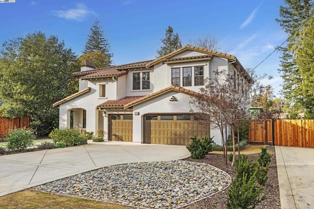 mediterranean / spanish-style home with a garage