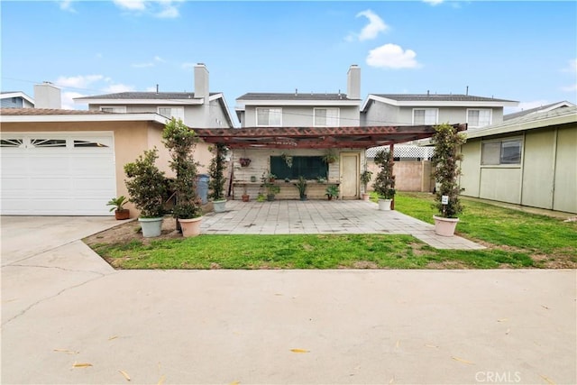 back of house featuring a pergola, a lawn, and a patio