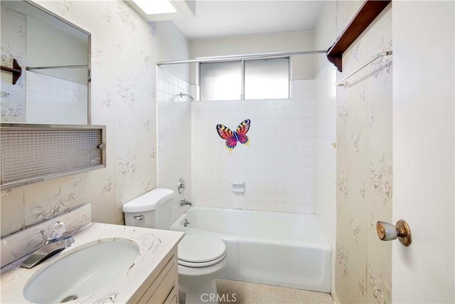 full bathroom featuring toilet, tiled shower / bath, and vanity