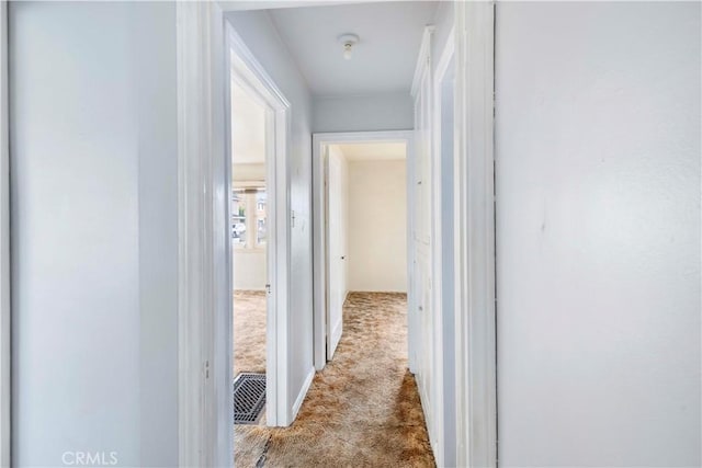 hallway with light colored carpet