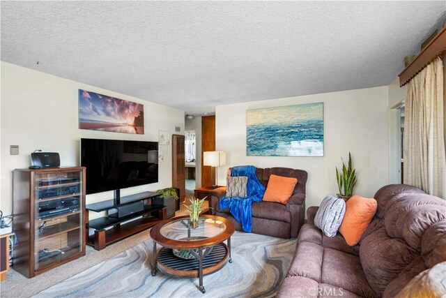 living room with light colored carpet and a textured ceiling