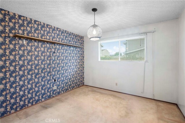 empty room with a textured ceiling