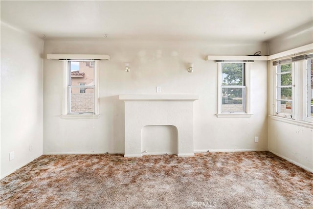 unfurnished living room featuring carpet