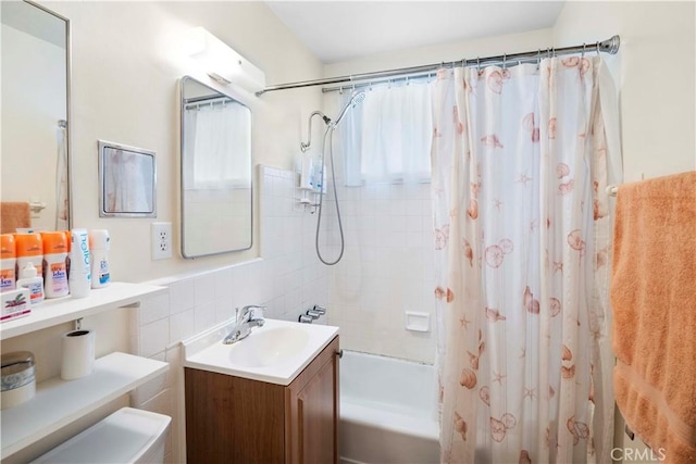 bathroom featuring vanity, tile walls, plenty of natural light, and shower / tub combo with curtain