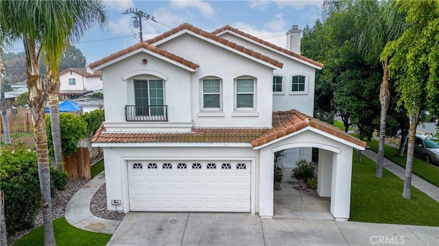 mediterranean / spanish-style home with a front lawn and a garage